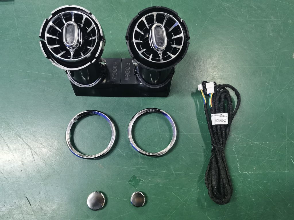 W205 rear vent units, trim rings, caps and harness laid out on a workbench