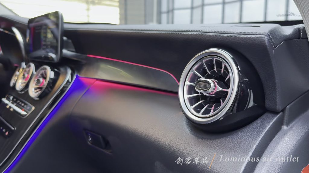 Illuminated passenger-side vent installed in the W205 dashboard. Full frame from the CKCP cabin showcase at 3.000 seconds; adjacent ambient-light strips are separate.